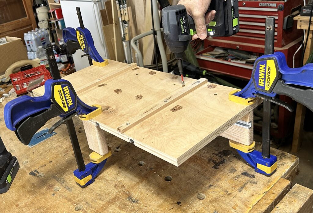 Screwing on the fences for the small parts crosscut sled for table saw